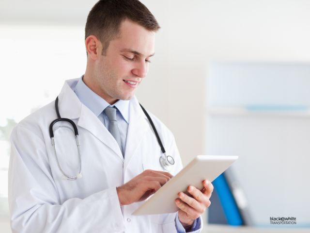 Healthcare Professional Using a Tablet to Schedule a Wheelchair Van Service