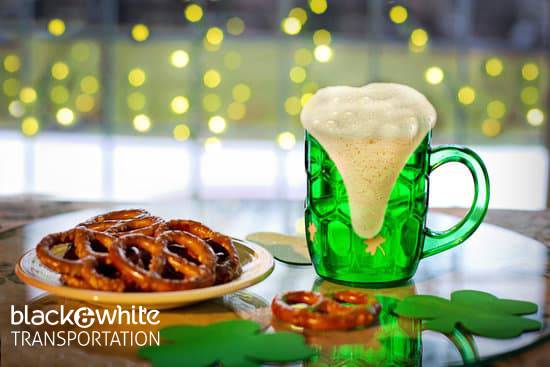 Beer Mug and Pretzels on a Bar Table With Shamrock Decorations