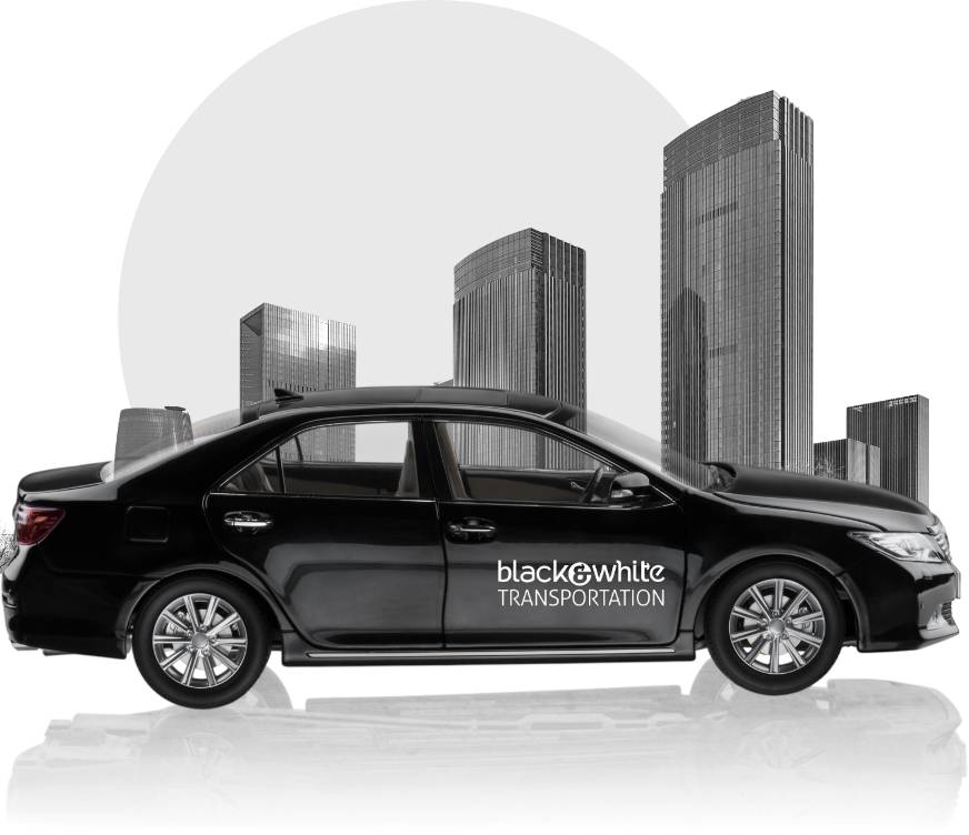 Black Car Parked in Front of the Downtown Toledo Skyline